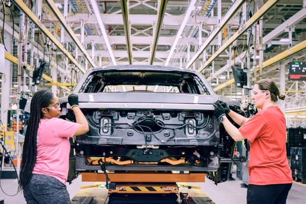 Two women assembling a truck